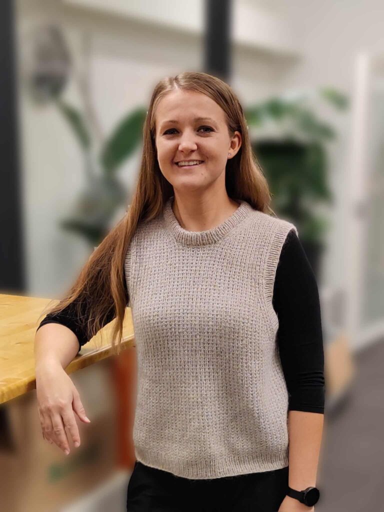 Kvinde smiler i moderne kontormiljø